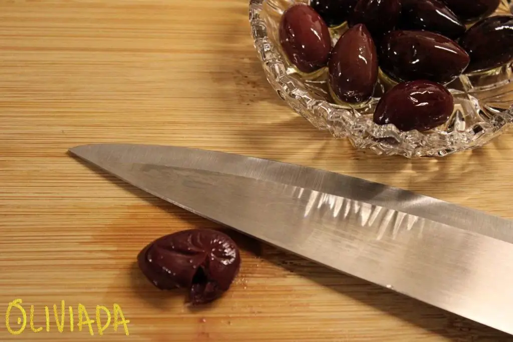pit olives with knife